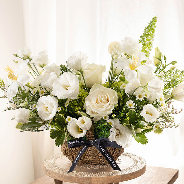 Bouquet of Tulips, Lisianthus, Green Hydrangea, Wax Flowers, White Stock, and Astrantia with Ruscus and Myrtle Leaves greeneries.