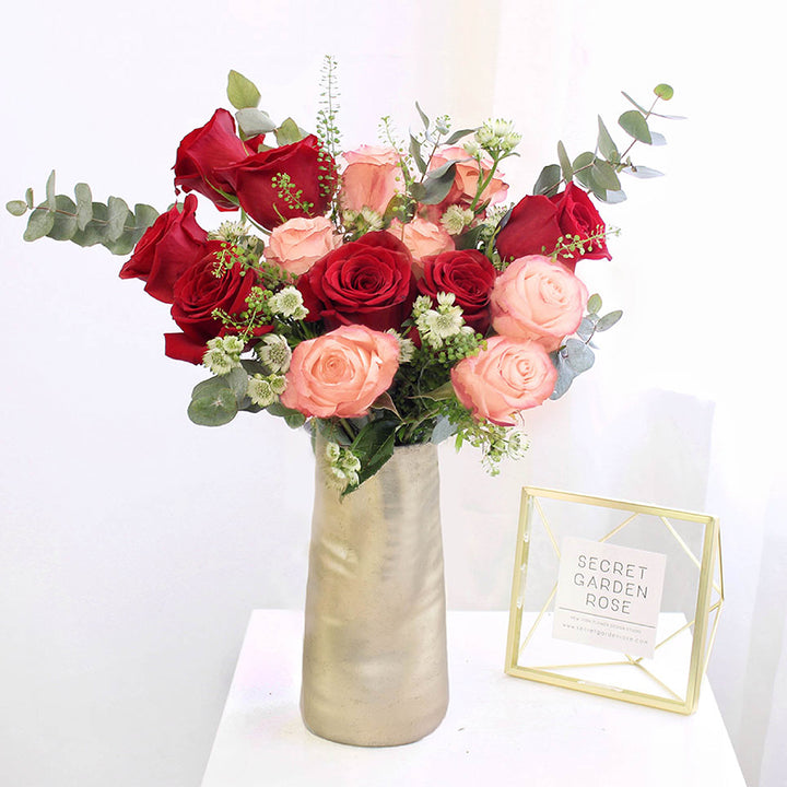 Bouquet of freedom roses kahala roses and astrantias with thlaspi and spiral eucalyptus greeneries.